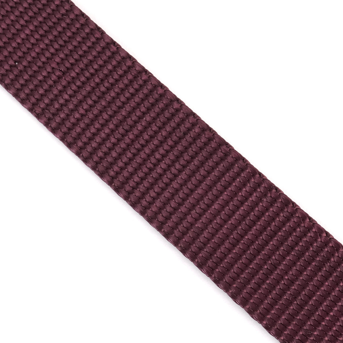 A close-up of a textured, woven dark burgundy ribbon or strap diagonally positioned on a plain white background.