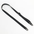 A black nylon webbing strap with black metal snap hooks on both ends and a black plastic buckle, laid out on a plain white background.