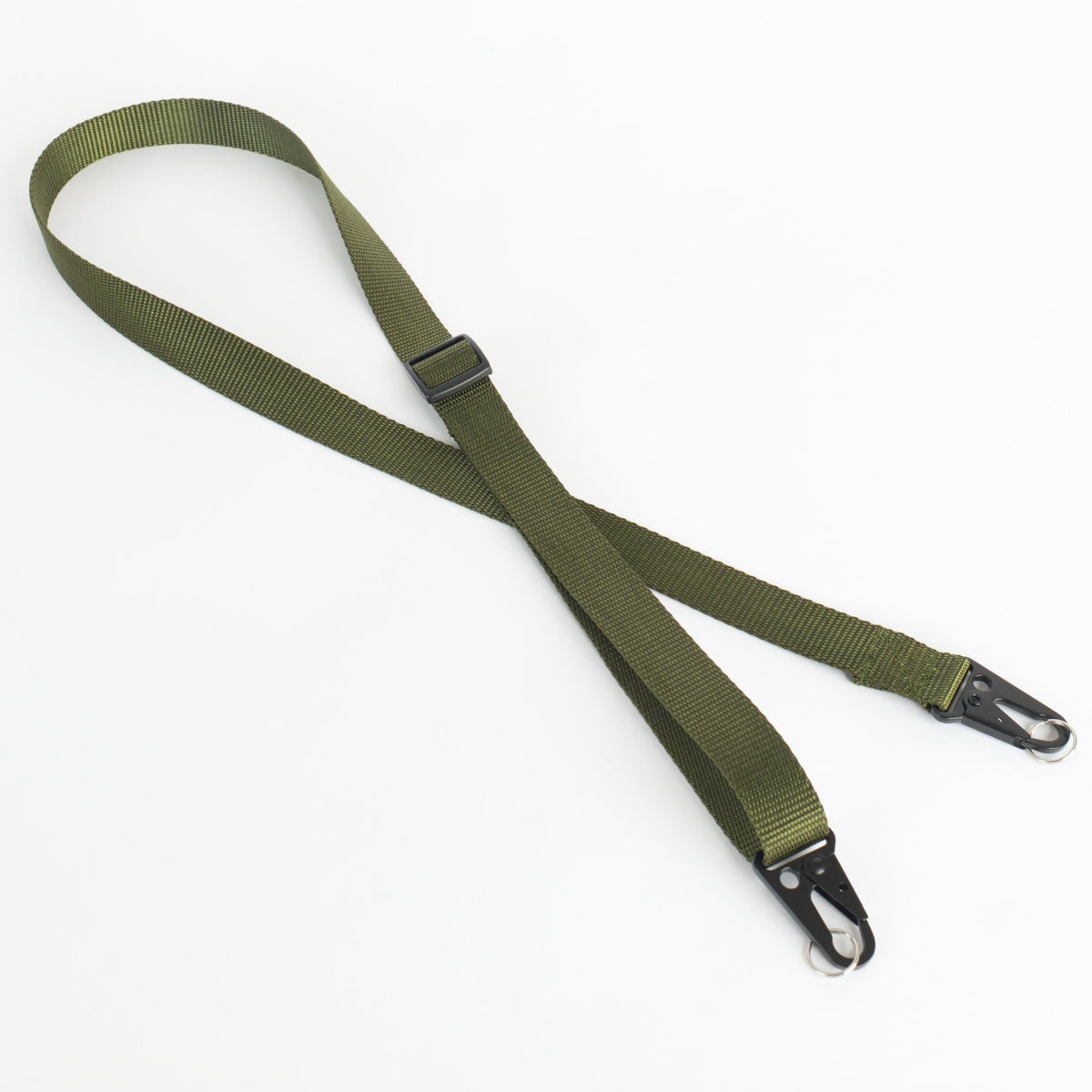 An olive green webbed sling strap with black metal quick-release hooks and a black plastic buckle, laid out on a white background.
