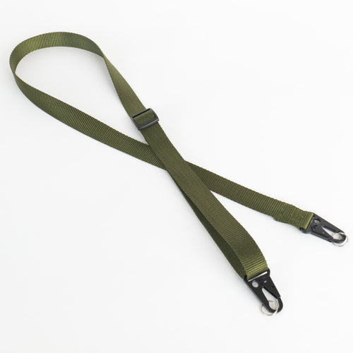 An olive green webbed sling strap with black metal quick-release hooks and a black plastic buckle, laid out on a white background.