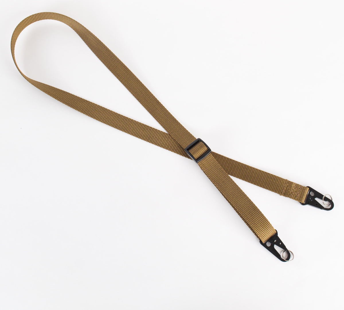 A tan nylon adjustable strap with black metal clips and black plastic slider, laid flat on a white background.
