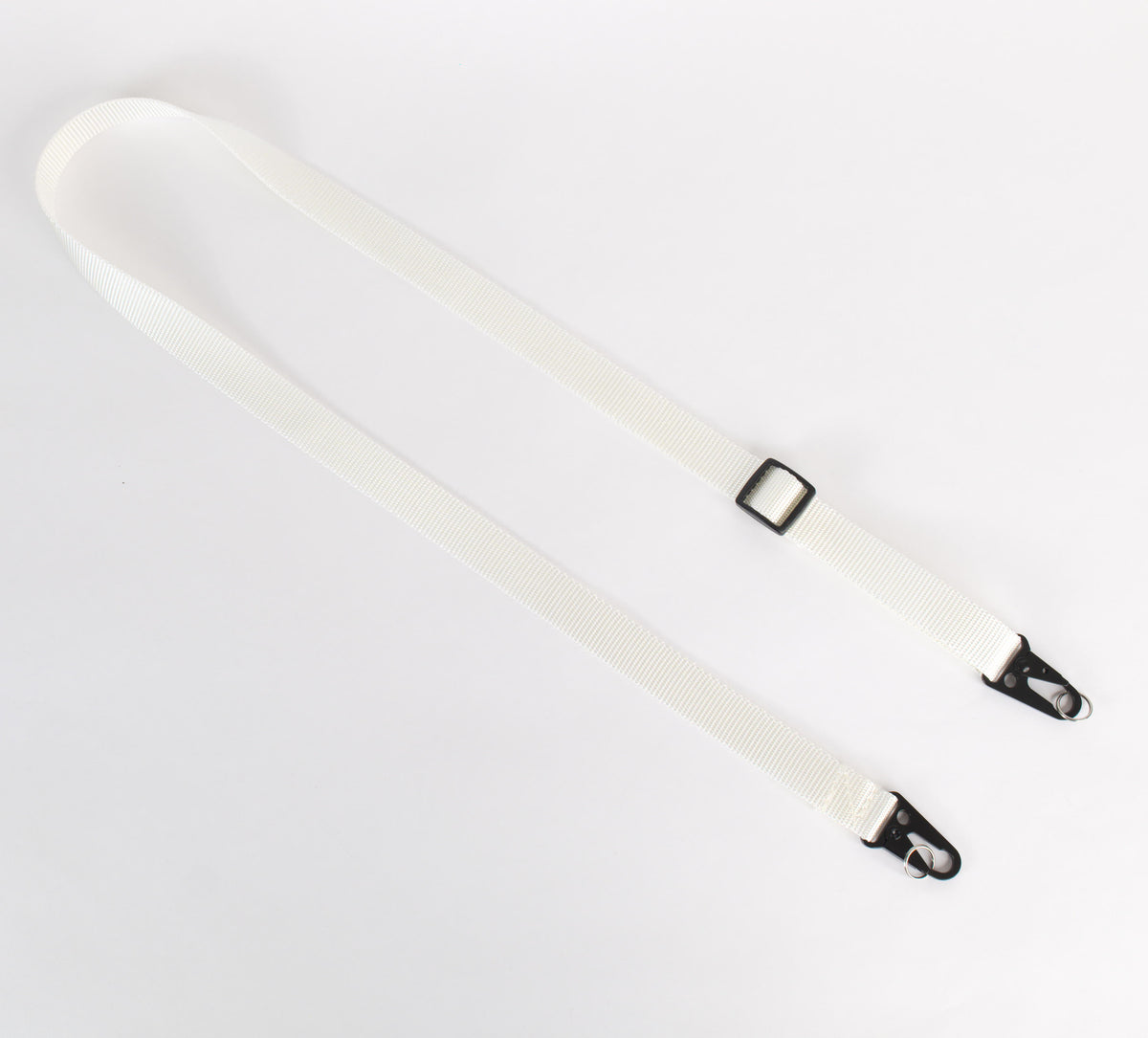 A single white adjustable strap with black metal clips and black plastic slider, laid flat on a white background.