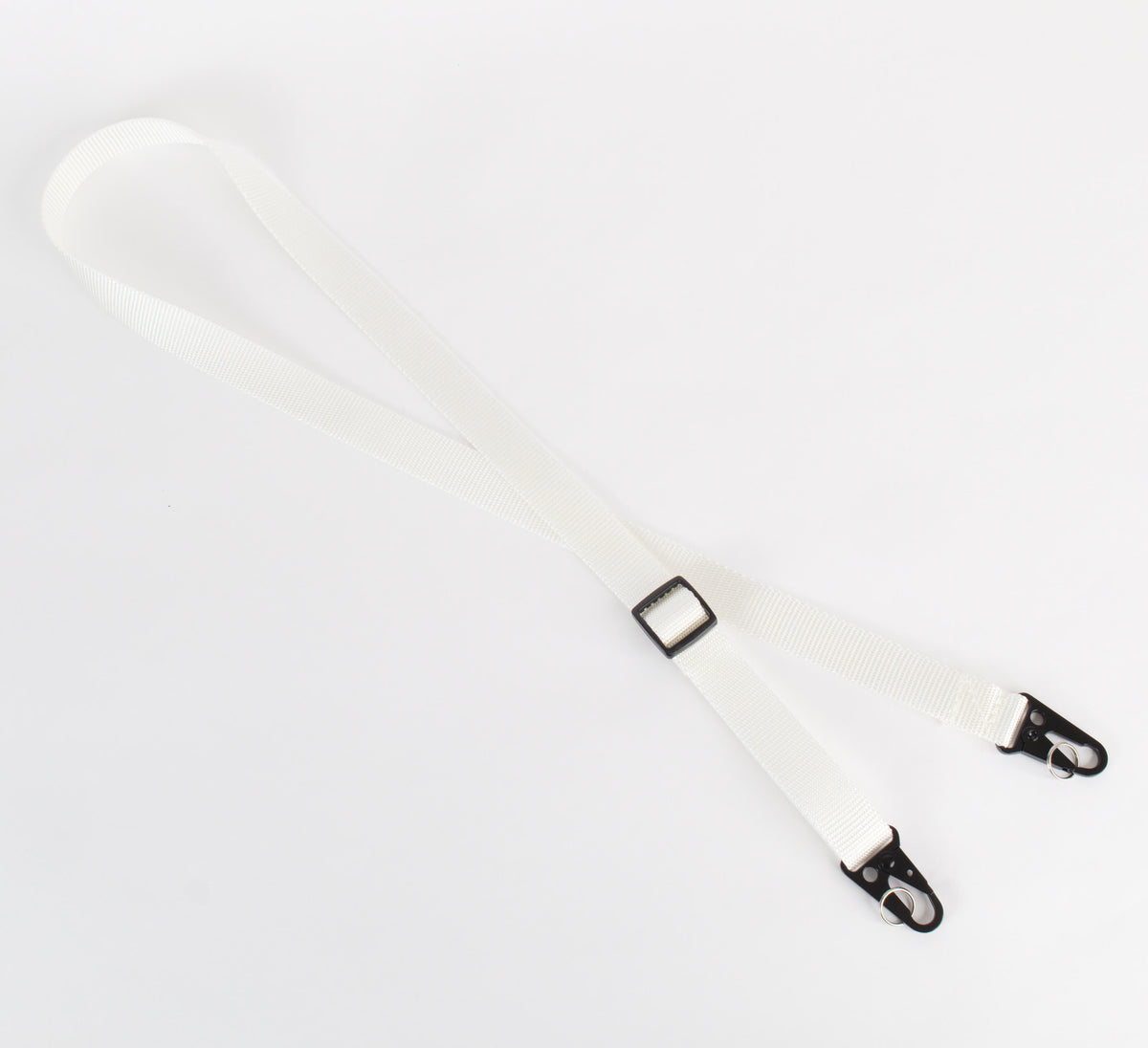 A single white adjustable strap with black metal clips and black plastic slider, laid flat on a white background.