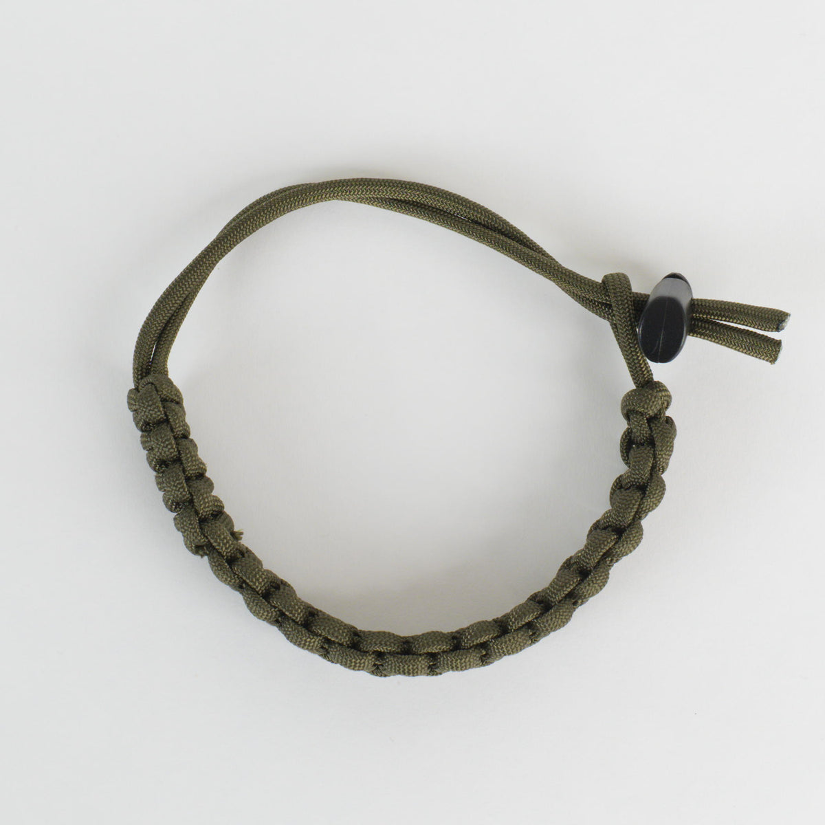 An olive green paracord bracelet with a knotted closure and a small black bead, shown on a clean white background.