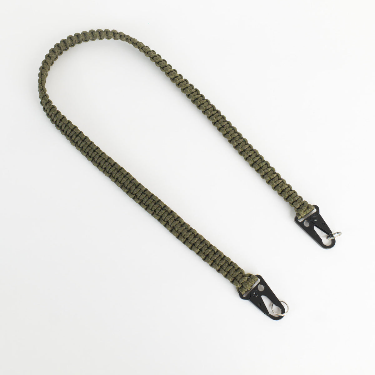 An olive green paracord camera strap with black metal swivel clips, displayed on a clean white background.