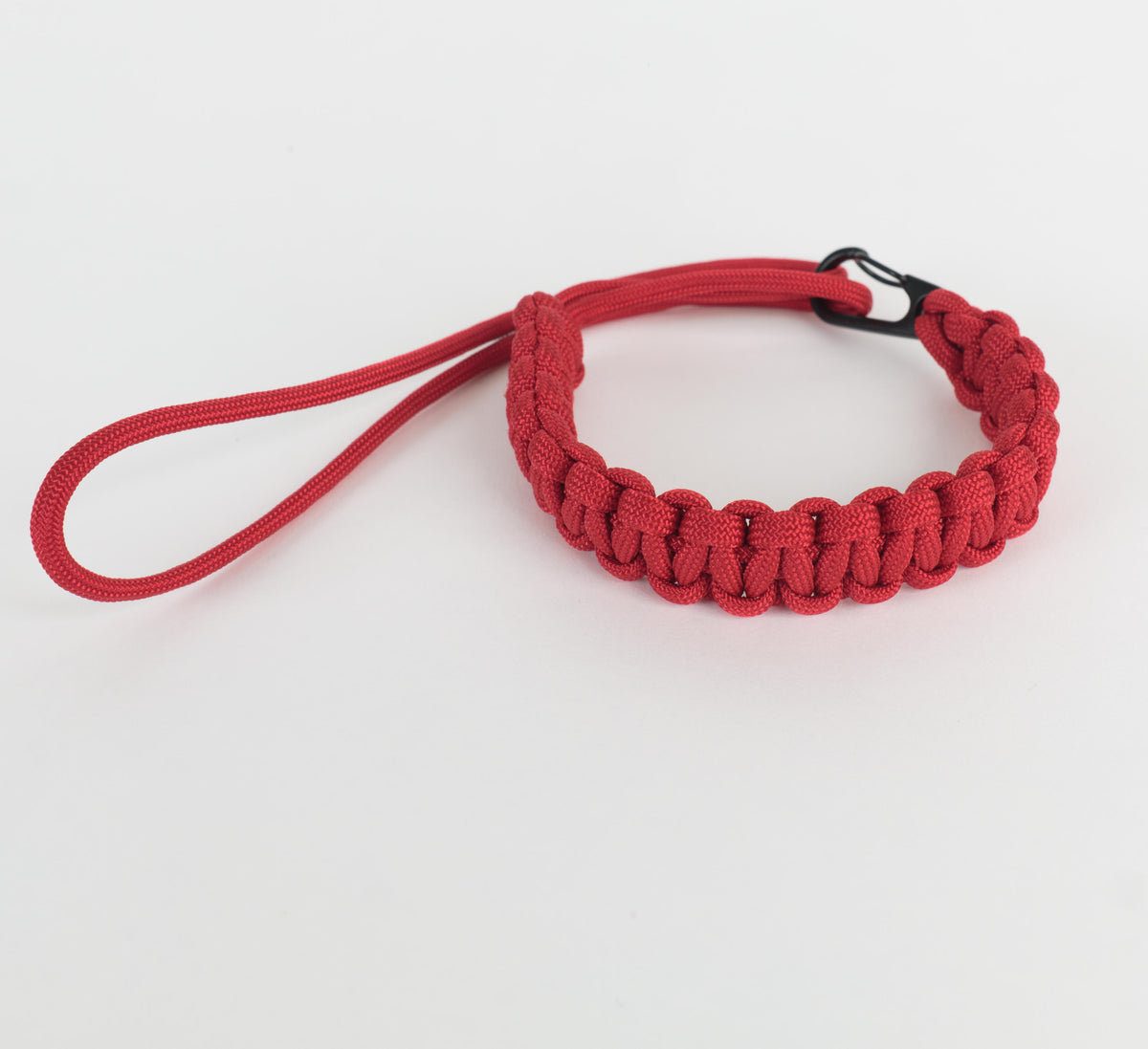 A red paracord wrist strap with a black metal clip, shown on a clean white background.