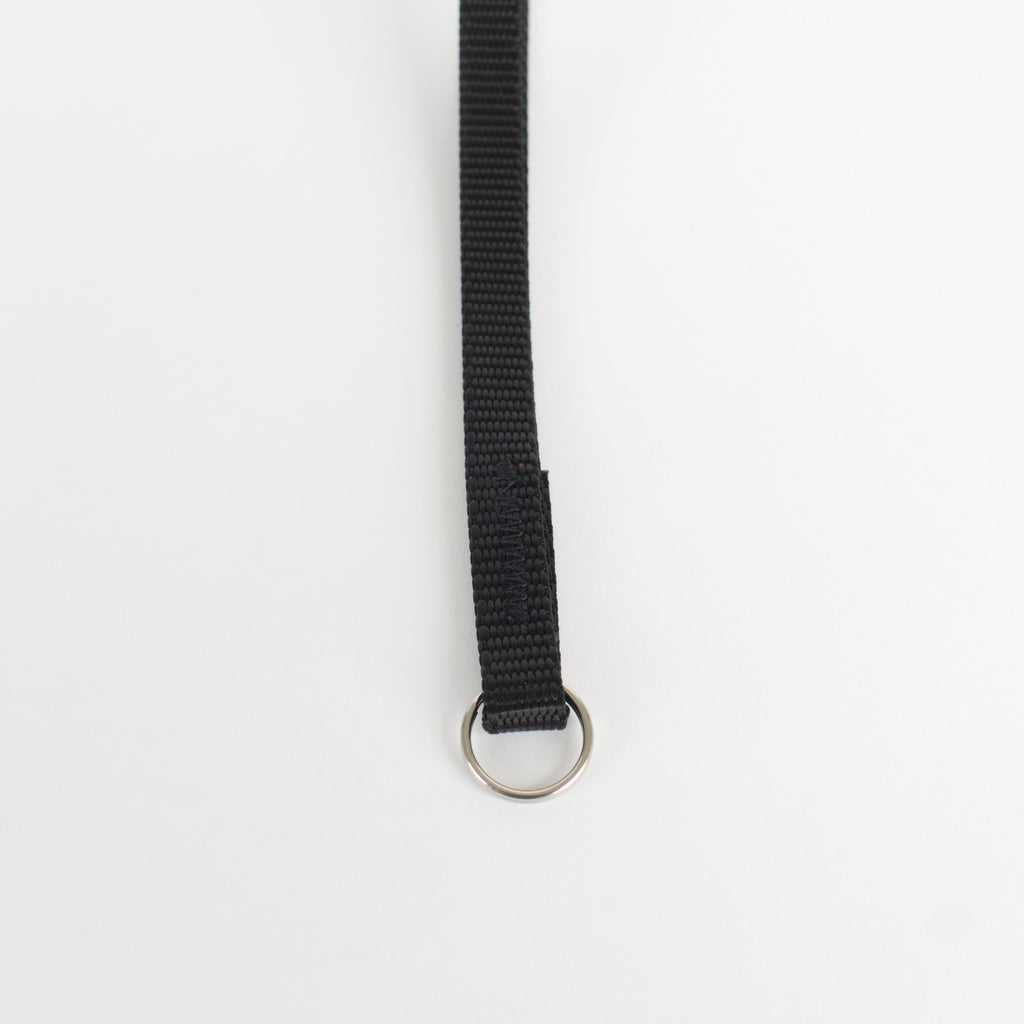 a close up of the stitching and split ring end of a small nylon wrist strap.