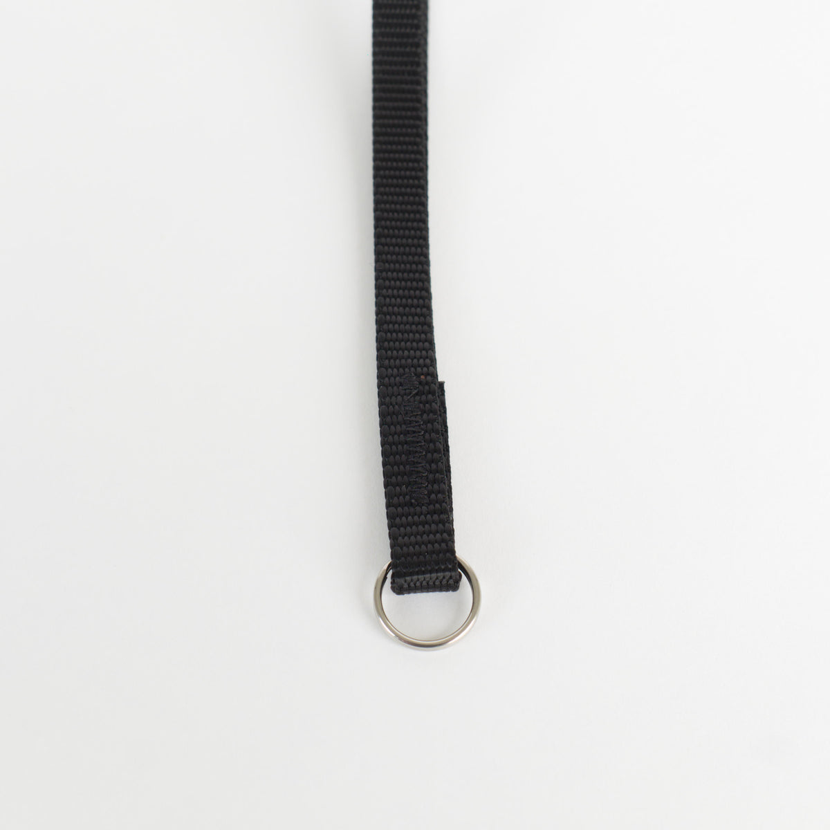 a close up of the stitching and split ring end of a small nylon wrist strap.